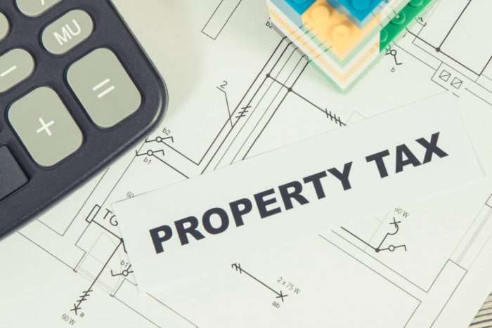 Inscription,Property,Tax,With,Small,House,Made,Of,Colorful,Toy