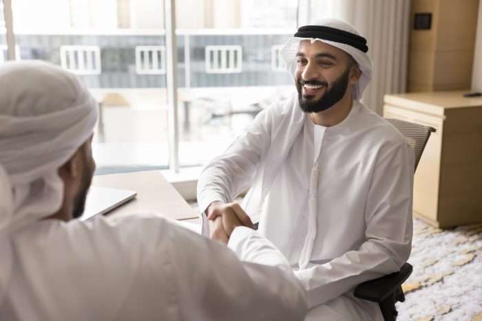 Cheerful,Young,Arabian,Business,Owner,Man,In,White,Keffiyeh,Shaking